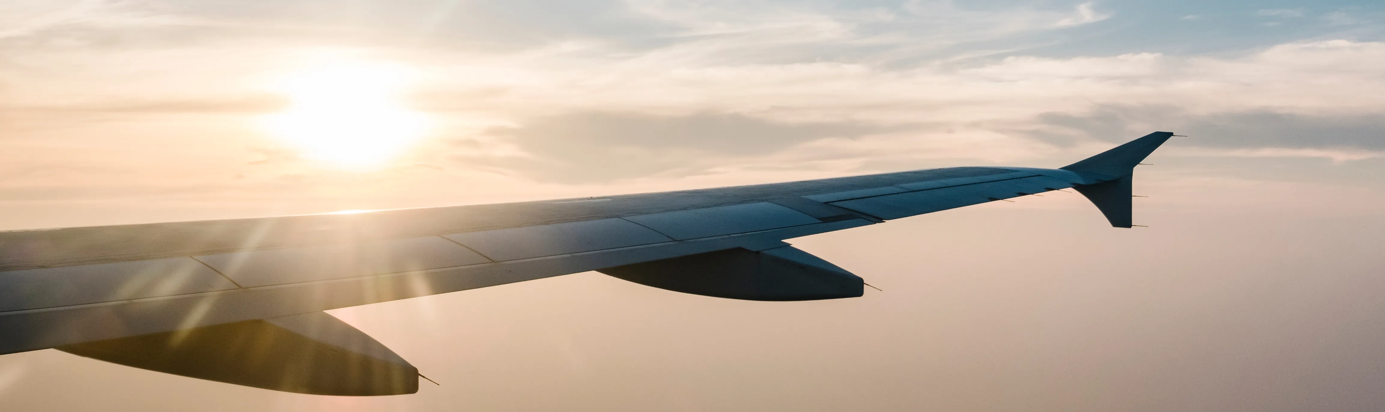 Airplane wing at sunset